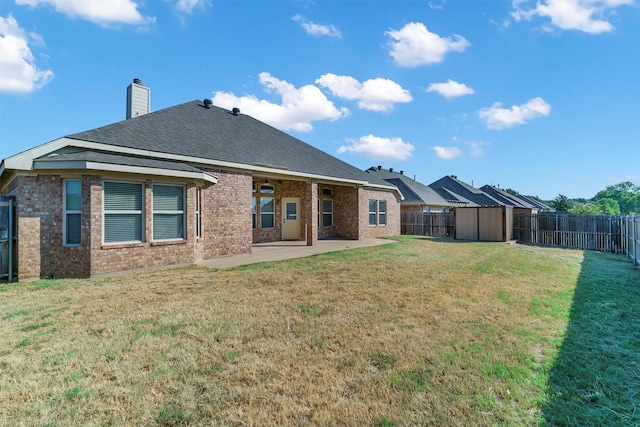 rear view of property featuring a patio and a yard