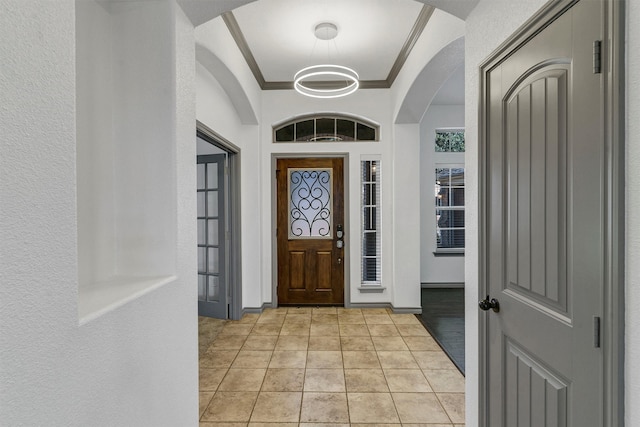 entryway featuring a tray ceiling and light wood-type flooring