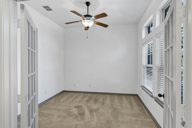 carpeted empty room featuring ceiling fan