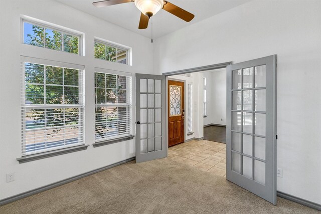 interior space with ceiling fan and french doors