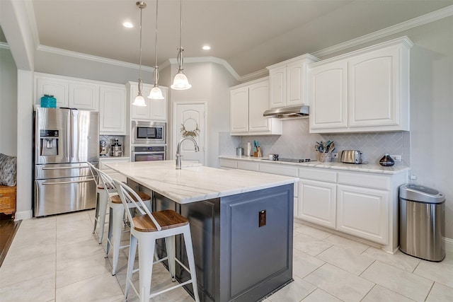 kitchen with decorative light fixtures, decorative backsplash, a kitchen island with sink, stainless steel appliances, and white cabinets