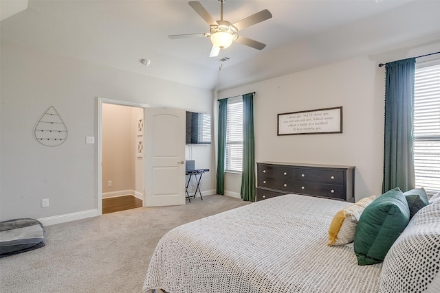 carpeted bedroom featuring ceiling fan and vaulted ceiling