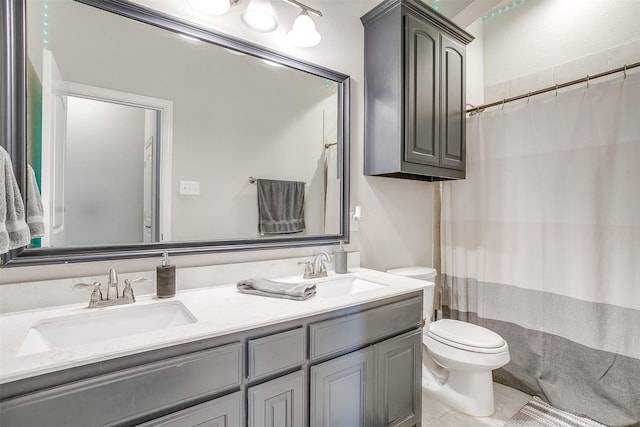 bathroom featuring tile patterned floors, curtained shower, vanity, and toilet