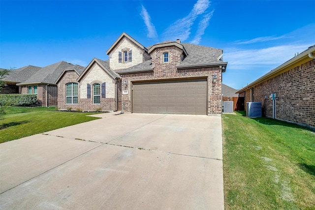 french country home with a garage, central AC, and a front yard