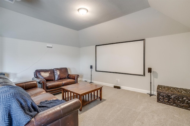 cinema with light carpet and lofted ceiling