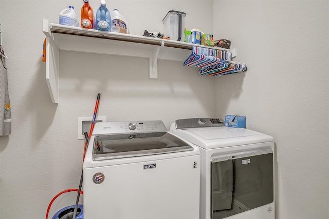 laundry area with washing machine and clothes dryer