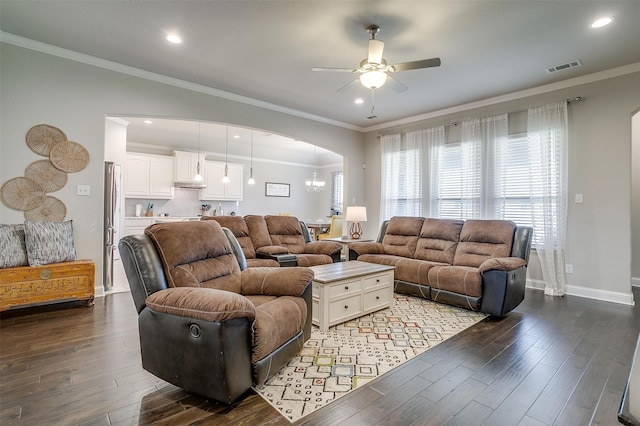 living room with hardwood / wood-style floors, ornamental molding, and ceiling fan