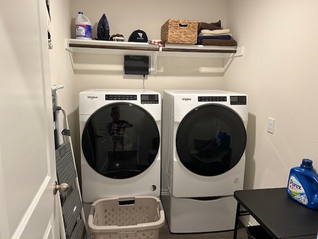 clothes washing area with washing machine and clothes dryer