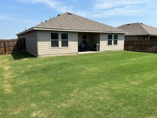 back of house with a lawn