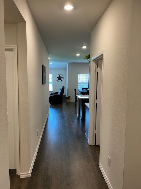 hall with dark wood-type flooring