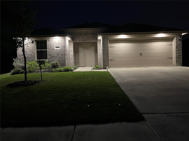 view of front of property featuring a garage and a front lawn