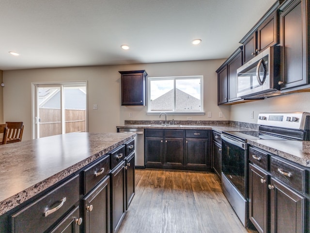 kitchen featuring plenty of natural light, sink, appliances with stainless steel finishes, and dark wood-type flooring