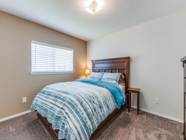 bedroom with dark colored carpet