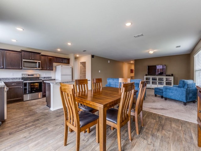 dining room with visible vents, wood finished floors, and recessed lighting