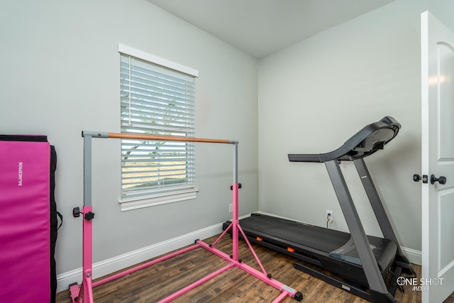 exercise area featuring wood finished floors and baseboards