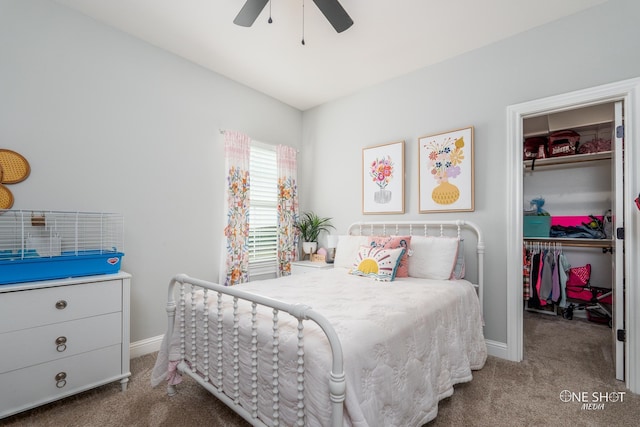 carpeted bedroom featuring ceiling fan, a spacious closet, baseboards, and a closet