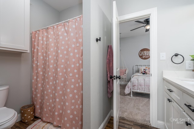 full bath featuring toilet, a ceiling fan, vanity, ensuite bath, and wood finished floors