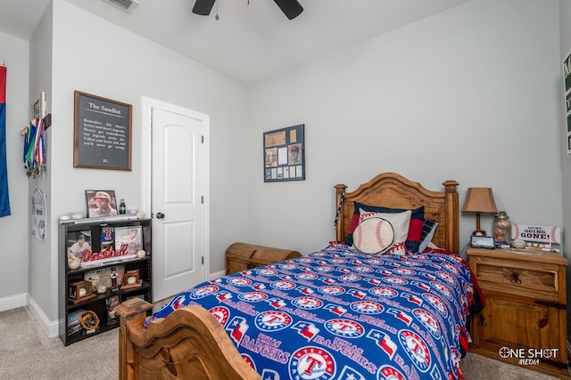 bedroom featuring light carpet, a ceiling fan, and baseboards