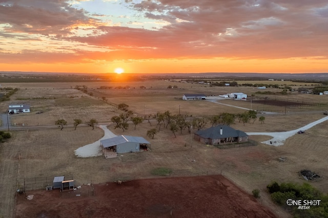 aerial view at dusk featuring a rural view