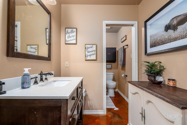 3085 County Road 131, Tuscola, TX 79562 - bathroom featuring vanity, baseboards, toilet, and finished concrete flooring