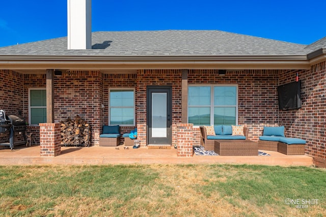 exterior space with a shingled roof, a lawn, a patio, an outdoor living space, and brick siding