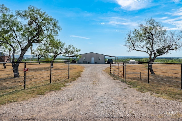 3085 County Road 131, Tuscola, TX 79562 - view of front of property with an outbuilding, a pole building, a rural view, dirt driveway, and a garage