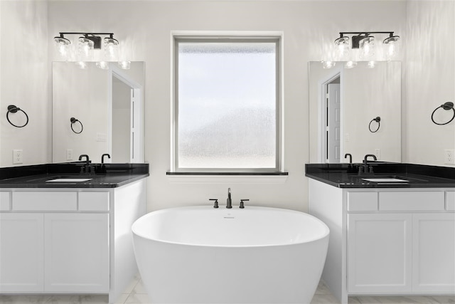 bathroom with vanity and a bath