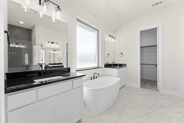 bathroom featuring vanity, a healthy amount of sunlight, shower with separate bathtub, and vaulted ceiling