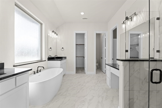 full bathroom featuring toilet, vanity, lofted ceiling, and shower with separate bathtub