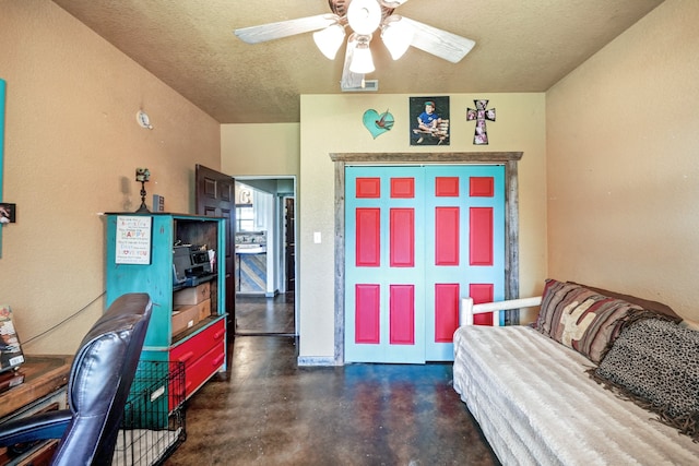 home office featuring ceiling fan and a textured ceiling