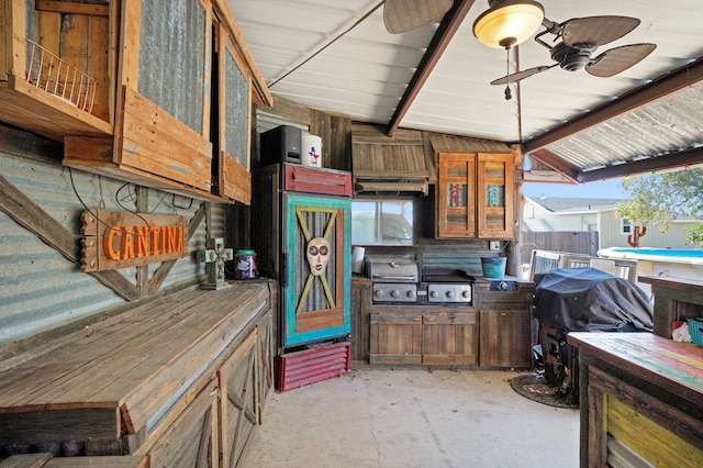 kitchen with ceiling fan and lofted ceiling