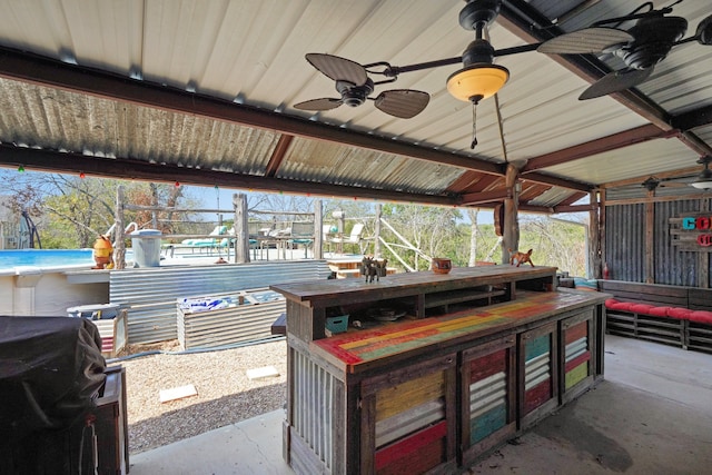 view of patio / terrace featuring ceiling fan, a grill, and an outdoor bar