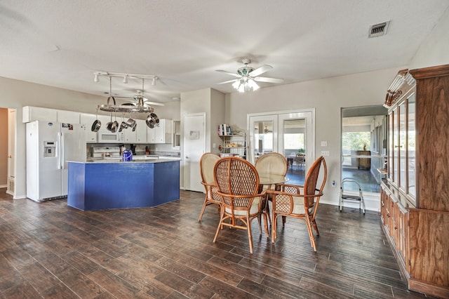 dining area with ceiling fan, dark hardwood / wood-style floors, track lighting, french doors, and a textured ceiling