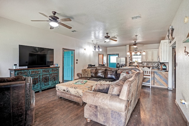 living room featuring a textured ceiling, ceiling fan, and dark hardwood / wood-style floors