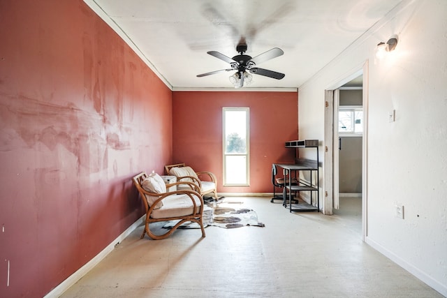 living area featuring ceiling fan, a wealth of natural light, and ornamental molding