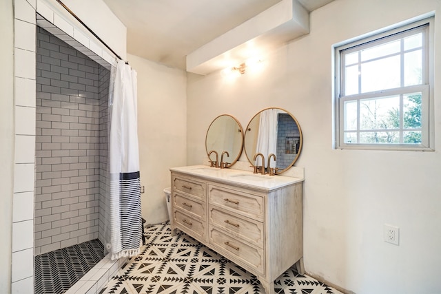 bathroom featuring tile patterned flooring, walk in shower, and vanity