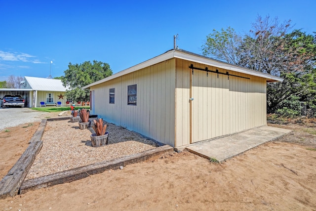 view of home's exterior featuring a carport and an outbuilding