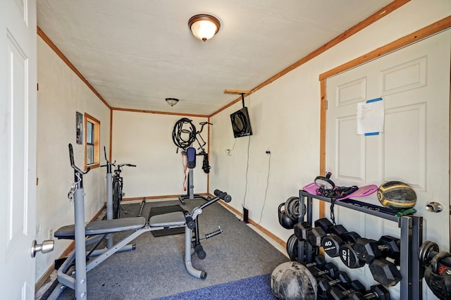 workout area with carpet floors and ornamental molding