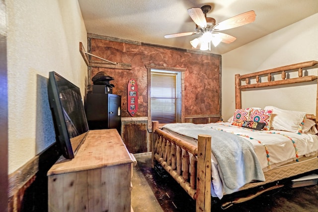 bedroom with ceiling fan and a textured ceiling