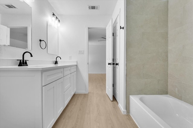 bathroom with ceiling fan, wood-type flooring, and vanity