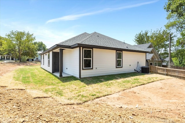 rear view of property with cooling unit