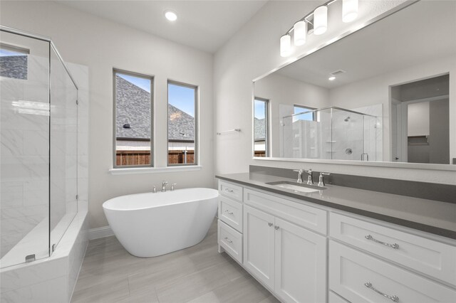 2001 Rockwood Ln, Mansfield, TX 76063 - full bathroom featuring recessed lighting, vanity, baseboards, a soaking tub, and a stall shower