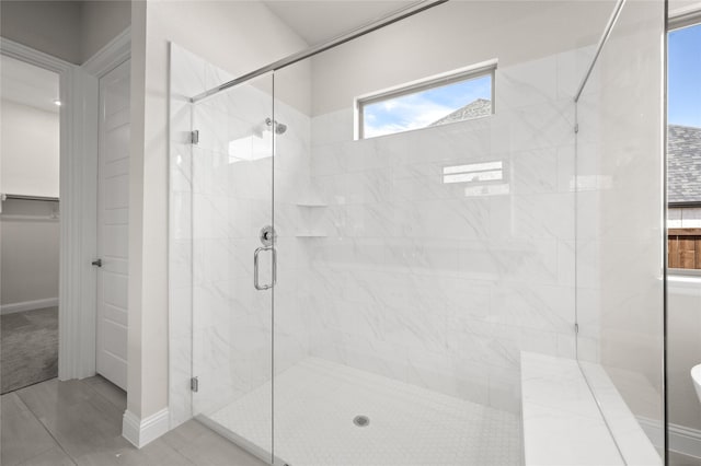2001 Rockwood Ln, Mansfield, TX 76063 - full bathroom featuring baseboards, a spacious closet, and a stall shower