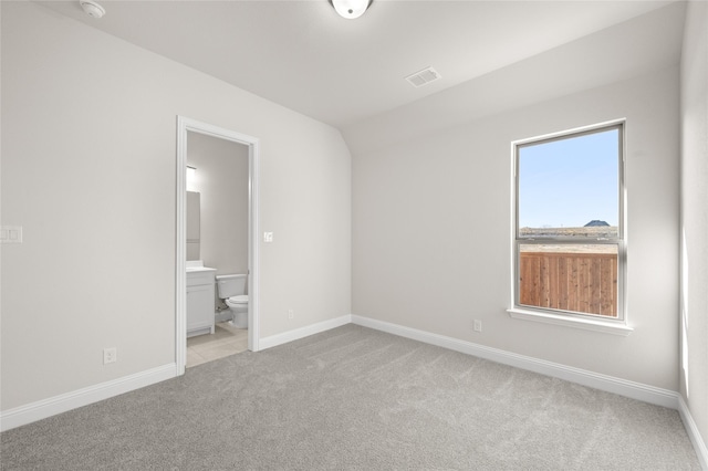2001 Rockwood Ln, Mansfield, TX 76063 - unfurnished bedroom with light colored carpet, baseboards, ensuite bathroom, and visible vents