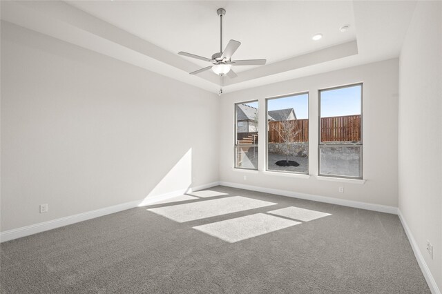 2001 Rockwood Ln, Mansfield, TX 76063 - empty room with a tray ceiling, carpet flooring, baseboards, and a ceiling fan