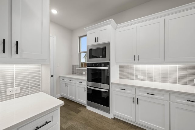 kitchen featuring stainless steel appliances, light countertops, a sink, and an island with sink