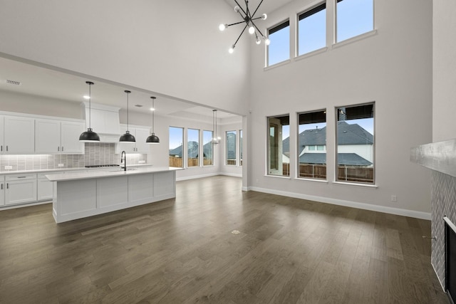 kitchen with dark wood-style floors, light countertops, appliances with stainless steel finishes, and white cabinetry