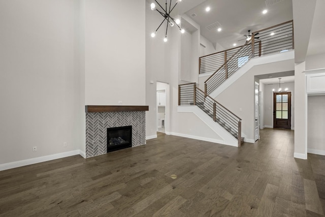 kitchen featuring dark wood-style floors, pendant lighting, stainless steel appliances, decorative backsplash, and white cabinetry