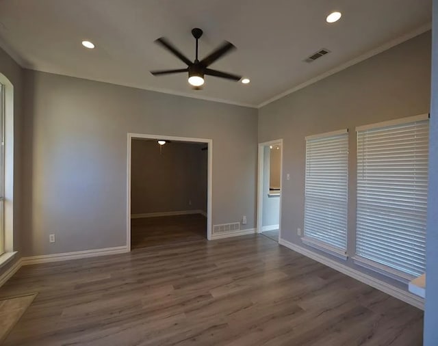 spare room featuring ornamental molding, ceiling fan, and dark hardwood / wood-style flooring