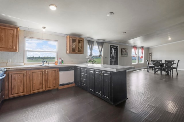 kitchen with a wealth of natural light, kitchen peninsula, and white dishwasher